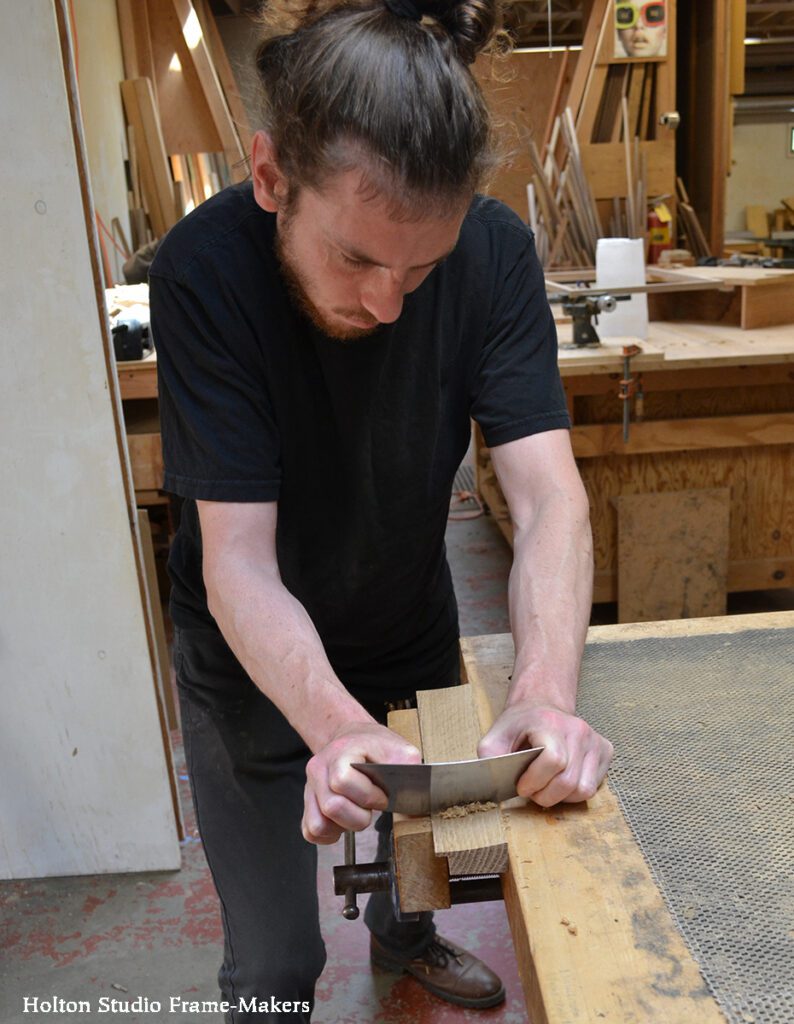 Craftsman using a scraper